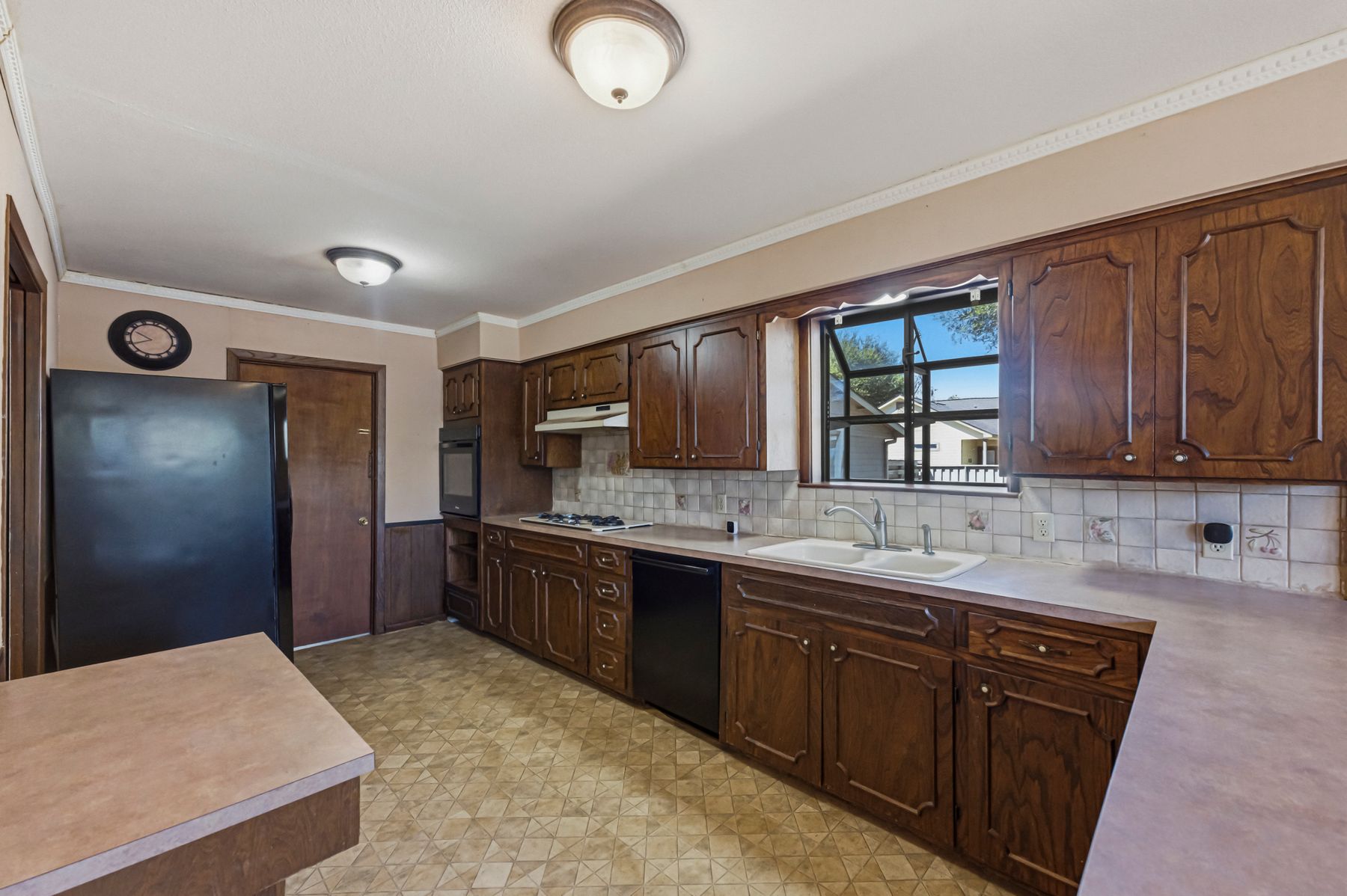 100 West 11th Street Elgin, TX 78621 - Photo 15 of 32 a kitchen with stainless steel appliances granite countertop a stove sink and cabinets