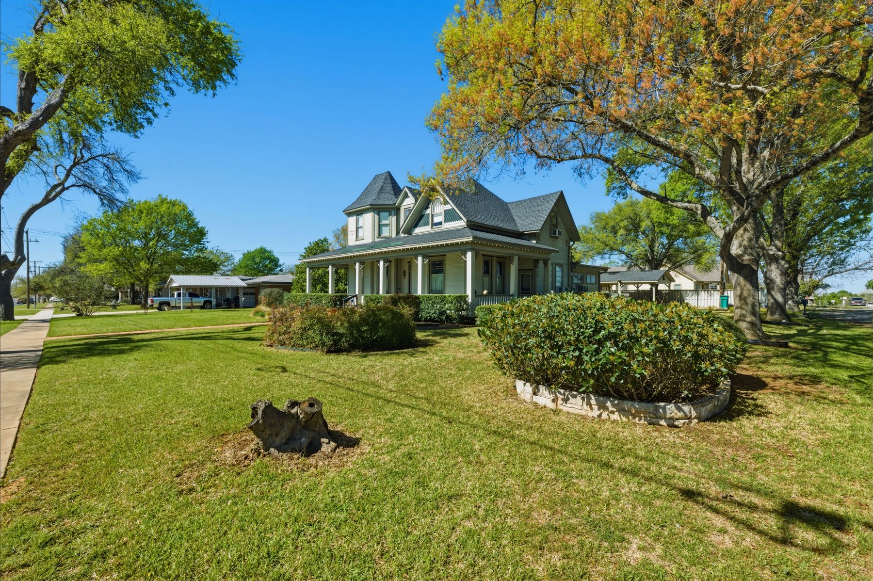 100 West 11th Street Elgin, TX 78621 - Photo 2 of 32 a view of a house with a yard and sitting area