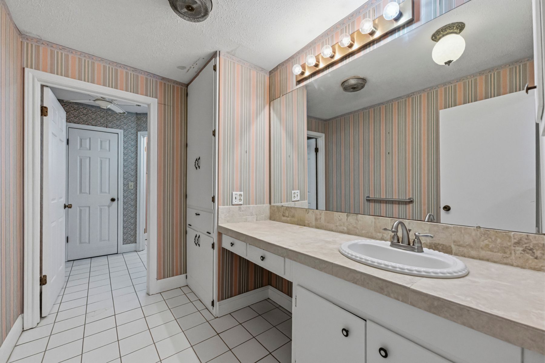 100 West 11th Street Elgin, TX 78621 - Photo 21 of 32 a bathroom with a granite countertop sink and a mirror