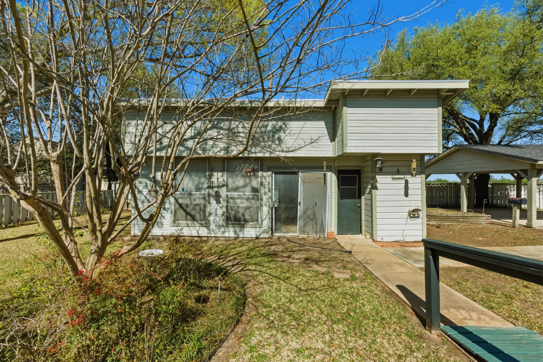 100 West 11th Street Elgin, TX 78621 - Photo 26 of 32 a view of a house with backyard and sitting area