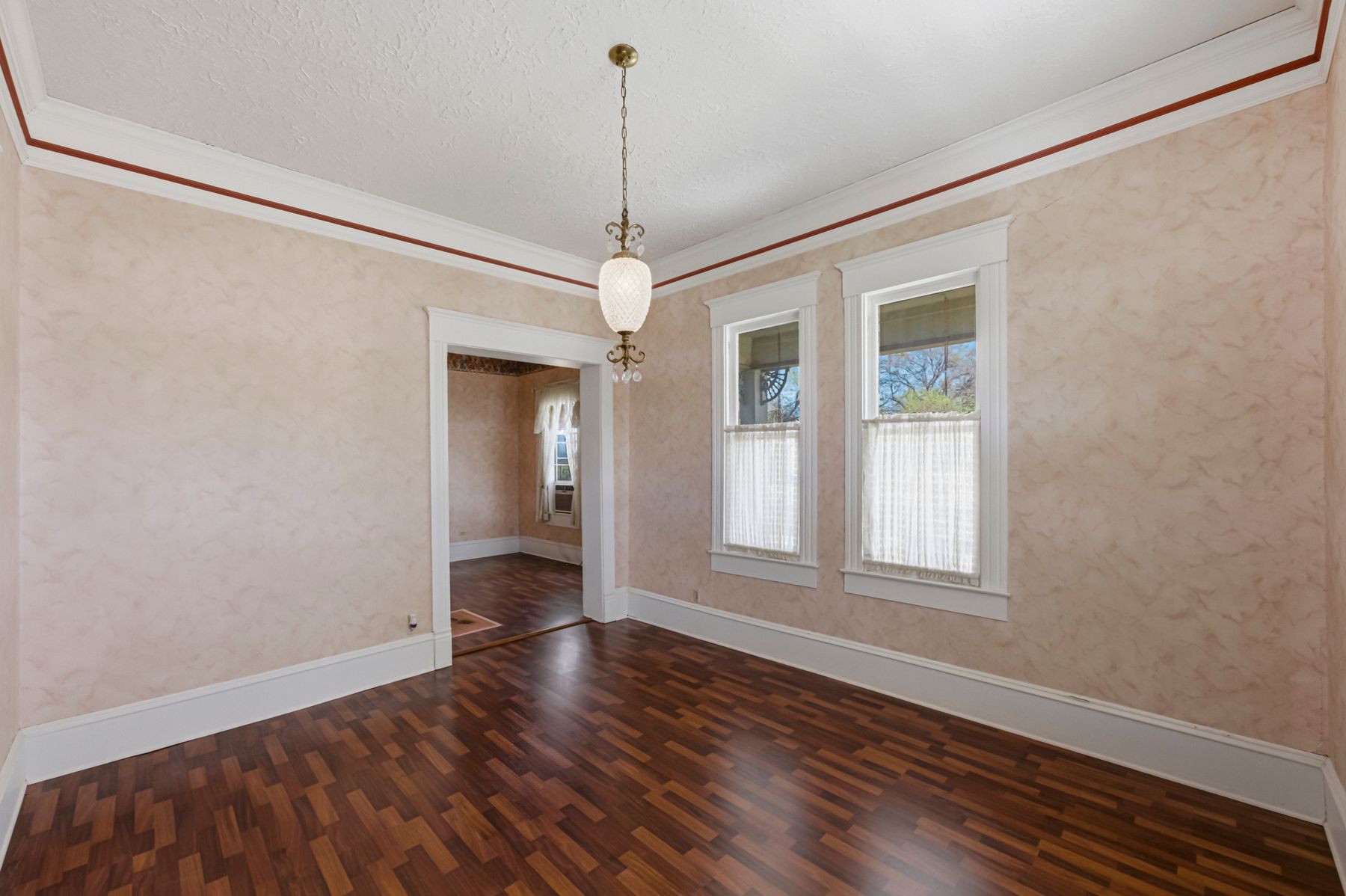 100 West 11th Street Elgin, TX 78621 - Photo 9 of 32 a view of an empty room with wooden floor and a window