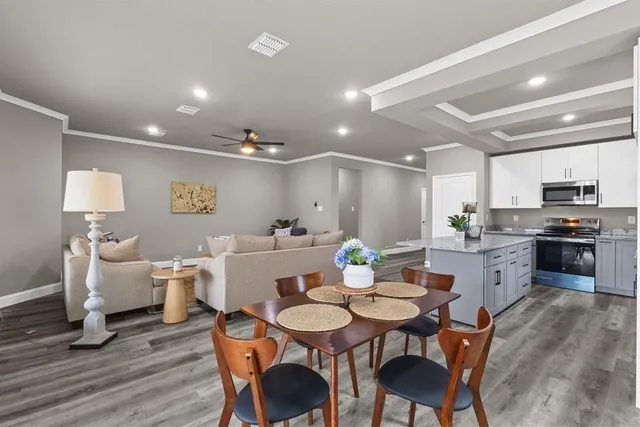 a view of a dining room with furniture and wooden floor
