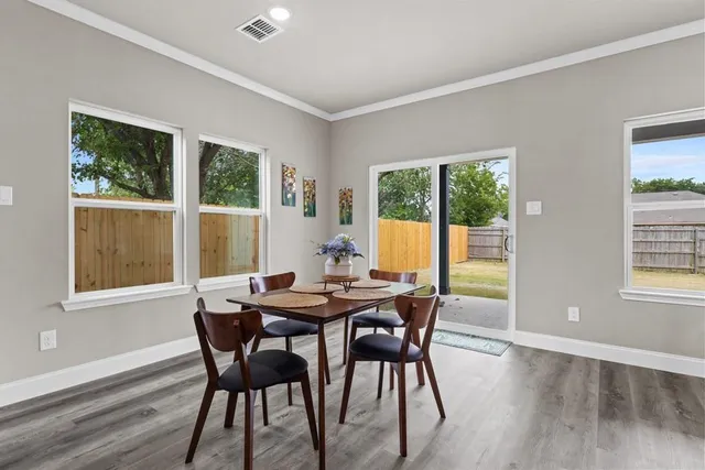 a view of a dining room with furniture and window