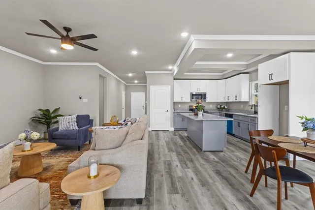 a kitchen with a dining table chairs sink and white appliances