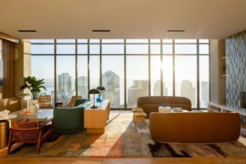 a bedroom with furniture and large windows