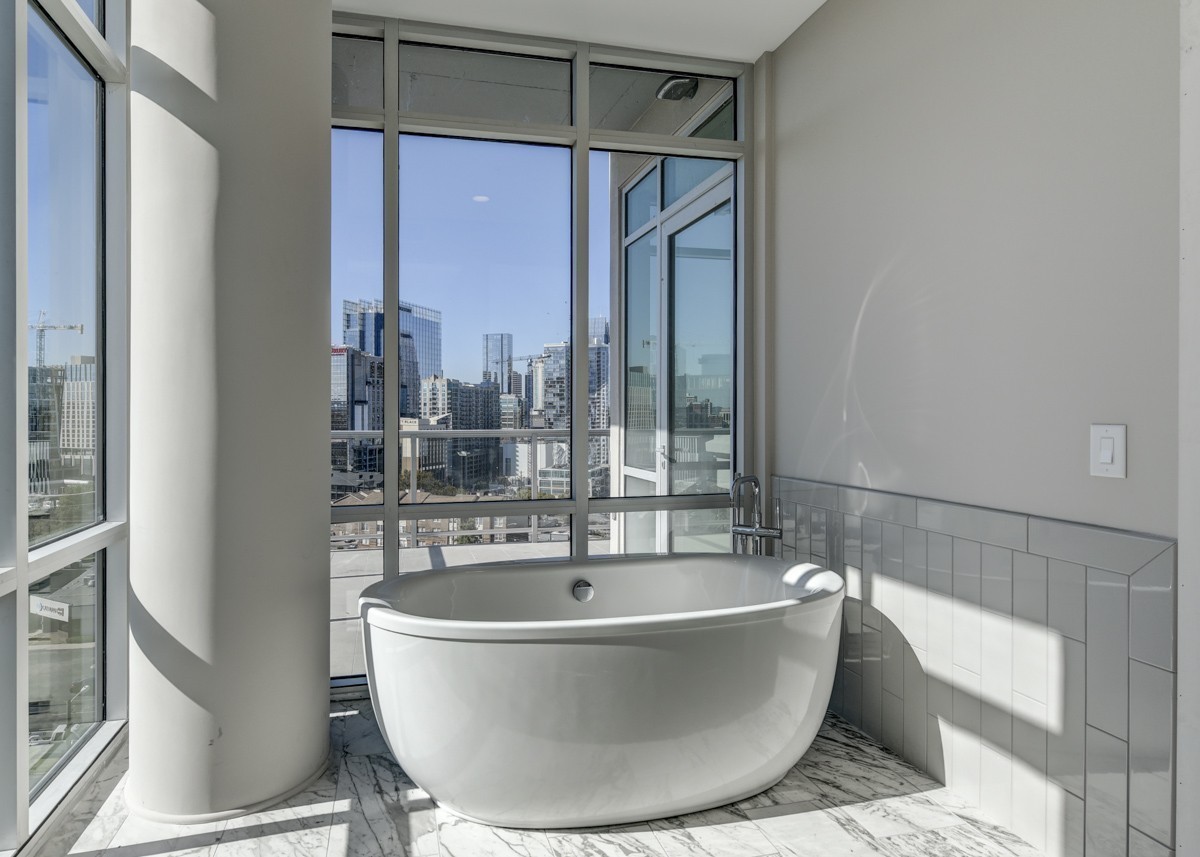 20 Rutledge Street, Unit 601 Nashville, TN 37210 - Photo 2 of 30 a white bath tub sitting in a bathroom next to a window