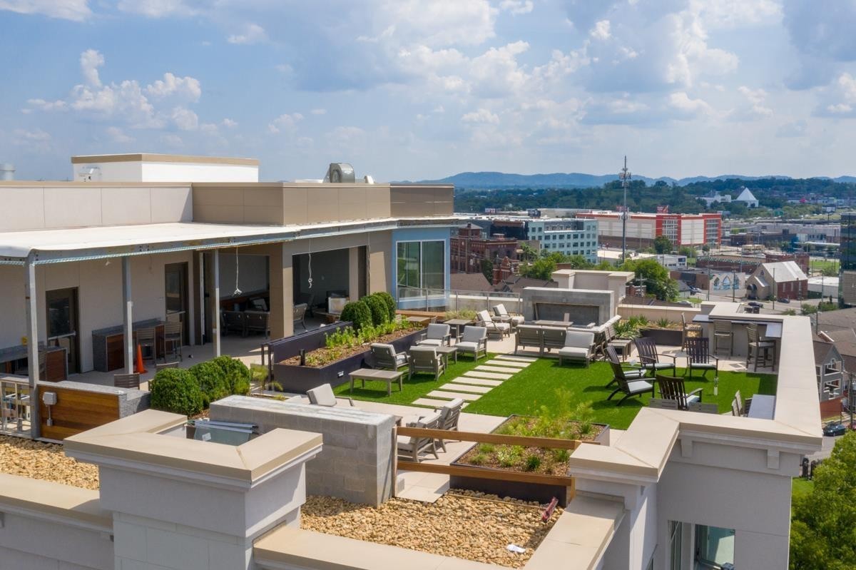 20 Rutledge Street, Unit 601 Nashville, TN 37210 - Photo 26 of 30 a view of a patio with couches table and chairs and potted plants
