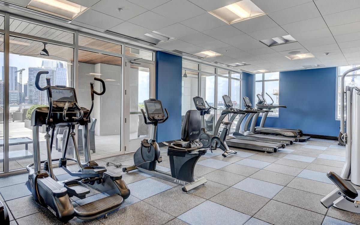 20 Rutledge Street, Unit 601 Nashville, TN 37210 - Photo 27 of 30 a room with gym equipment and large mirror