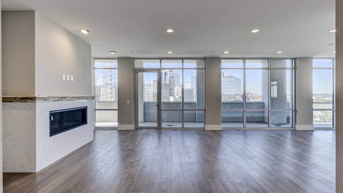 20 Rutledge Street, Unit 601 Nashville, TN 37210 - Photo 4 of 30 a view of an empty room with wooden floor fireplace and windows