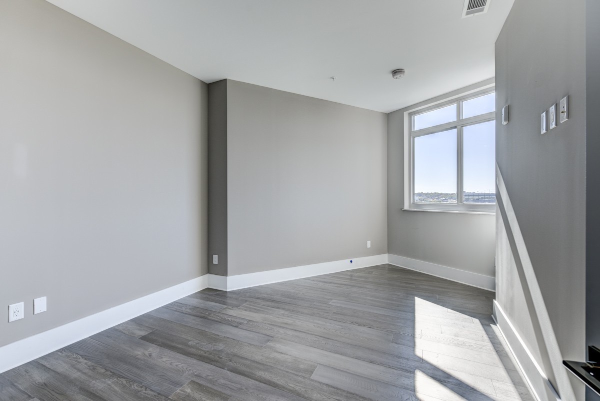 20 Rutledge Street, Unit 601 Nashville, TN 37210 - Photo 8 of 30 an empty room with wooden floor and windows