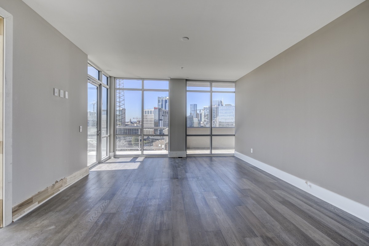20 Rutledge Street, Unit 601 Nashville, TN 37210 - Photo 10 of 30 wooden floor in an empty room with a window