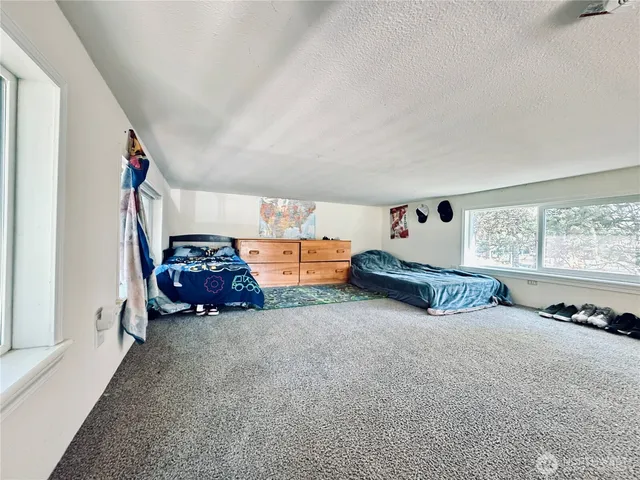 a view of a livingroom with toys and a window