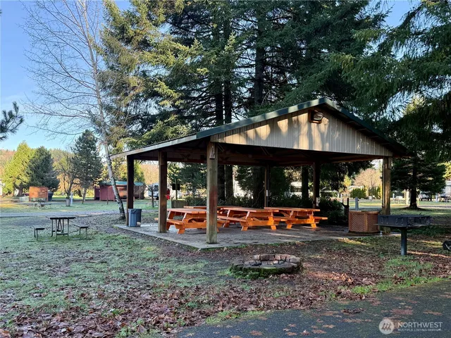 an outdoor sitting area with a tree