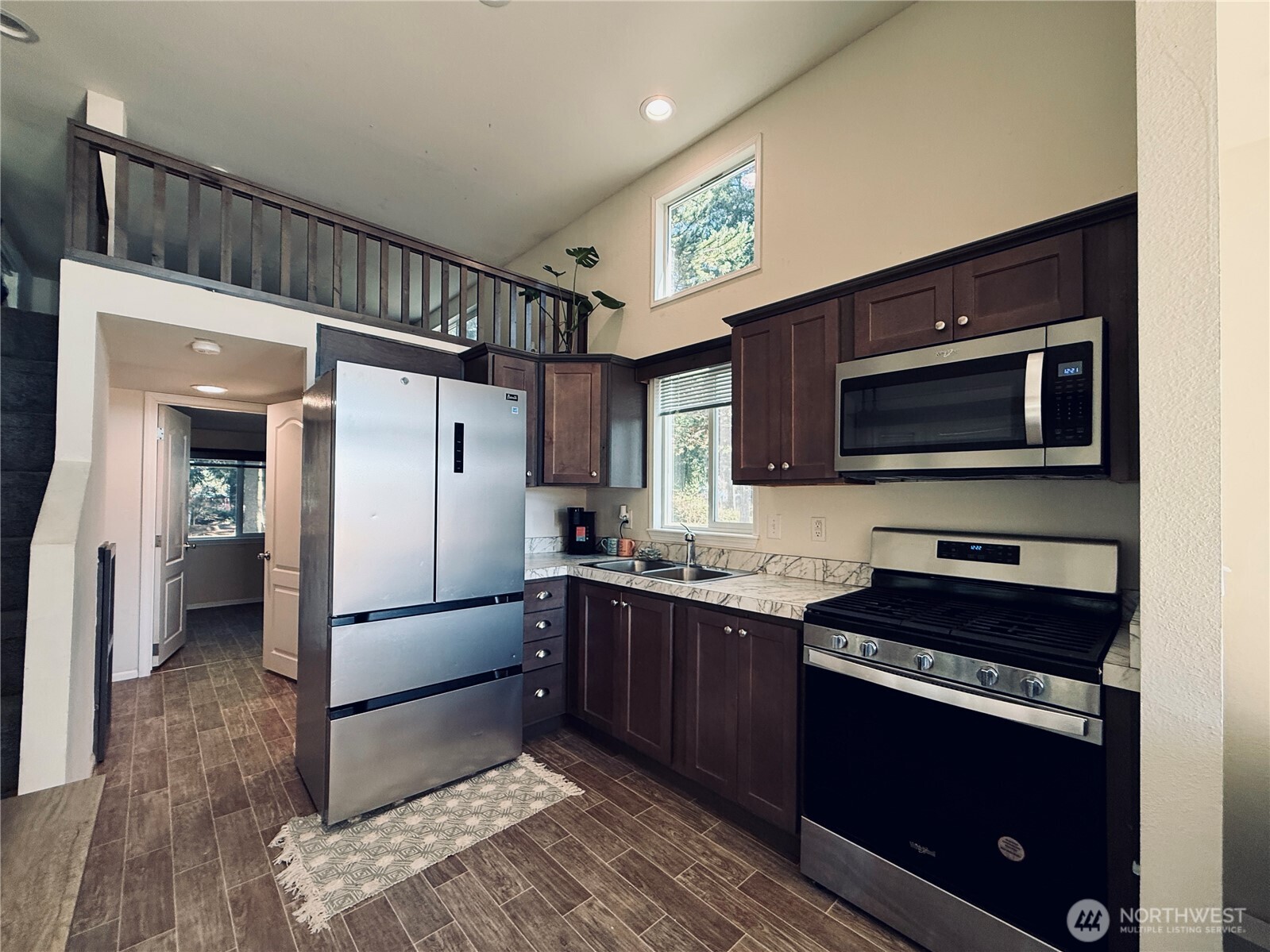 150 Happy Trails Road, Unit 119 Castle Rock, WA 98611 - Photo 6 of 20 a kitchen with stainless steel appliances a stove microwave and a refrigerator