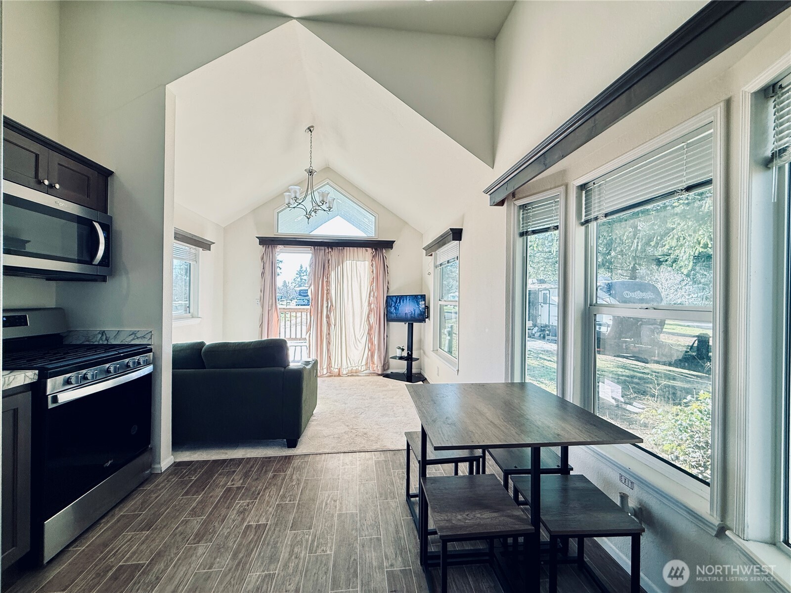 150 Happy Trails Road, Unit 119 Castle Rock, WA 98611 - Photo 10 of 20 a view of a dining room with furniture window and wooden floor