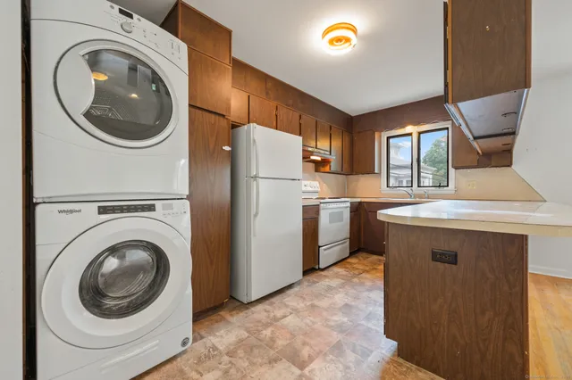 a kitchen that has a washer and dryer in it