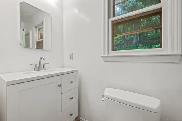 a bathroom with a toilet sink and window