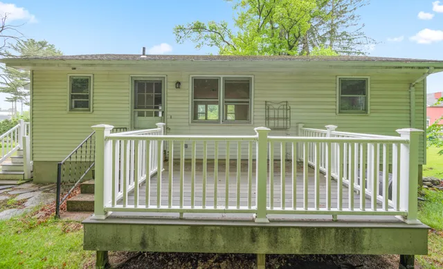 a view of a house with a small deck