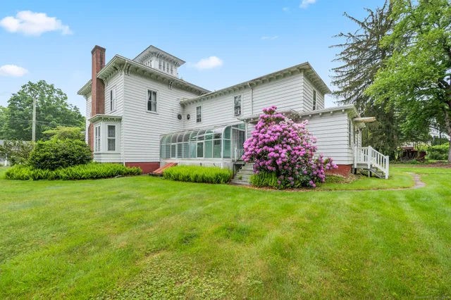 a front view of house with yard and green space