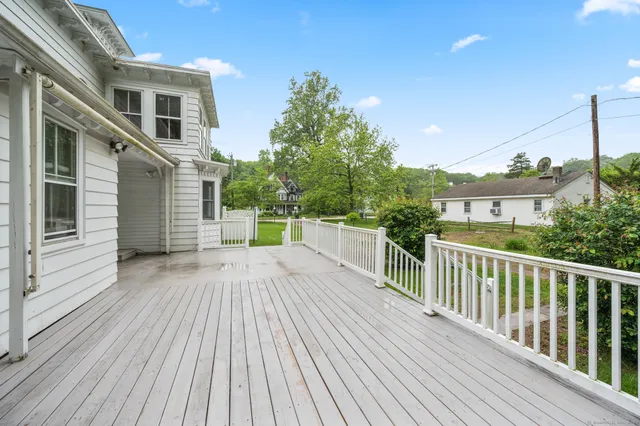 a view of a wooden deck with a yard