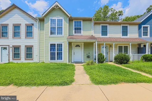 front view of a house next to a yard