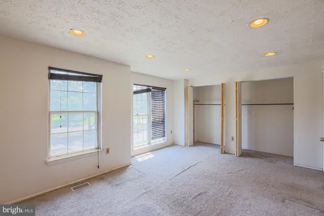 an empty room with a empty space and windows