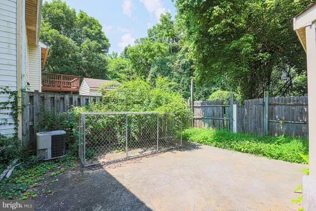 a backyard of a house with plants and outdoor seating