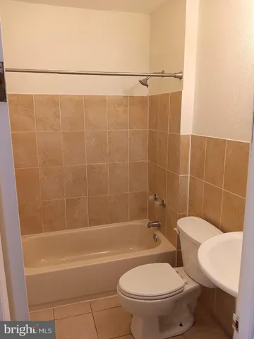 a bathroom with a toilet a sink and bathtub