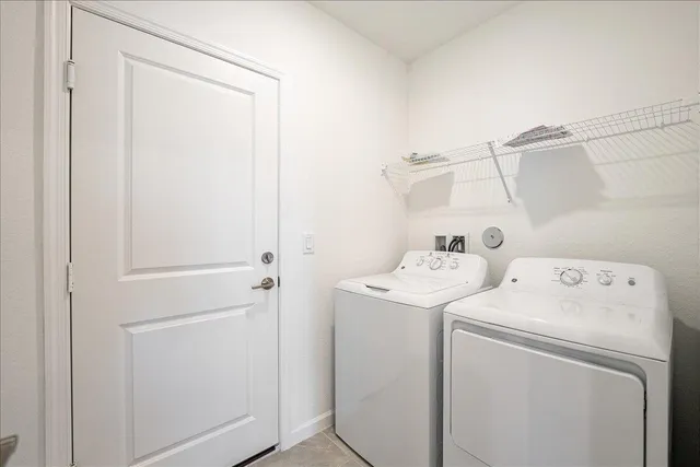a view of storage and utility room with washer and dryer