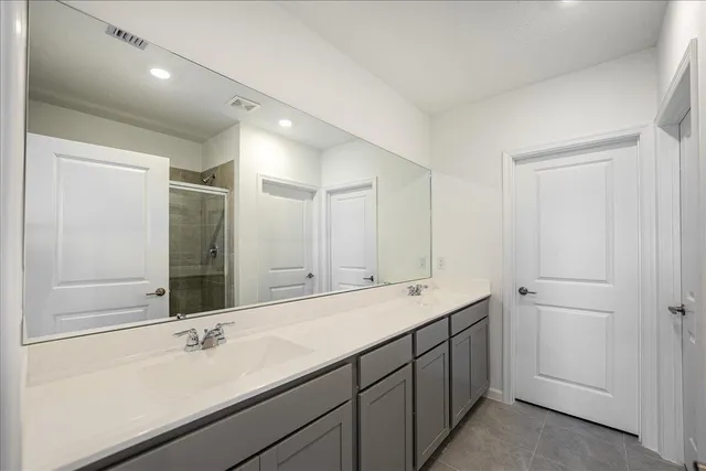 a bathroom with a double vanity sink and mirror