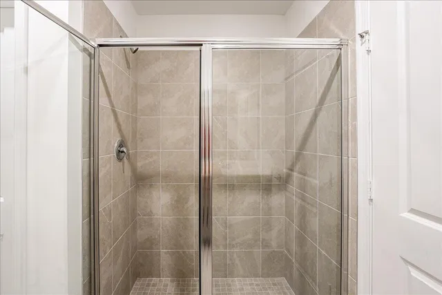 a bathroom with a glass door shower