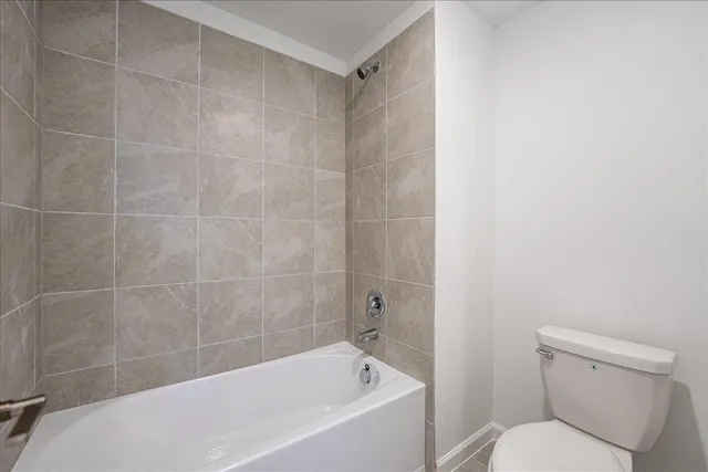 a white bath tub sitting next to a white toilet