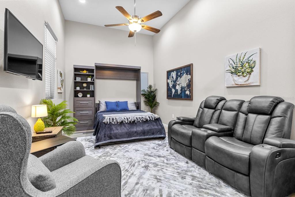 20 Captains Cove Road Inglis, FL 34449 - Photo 56 of 94 a bedroom with a bed a couch and a flat screen tv