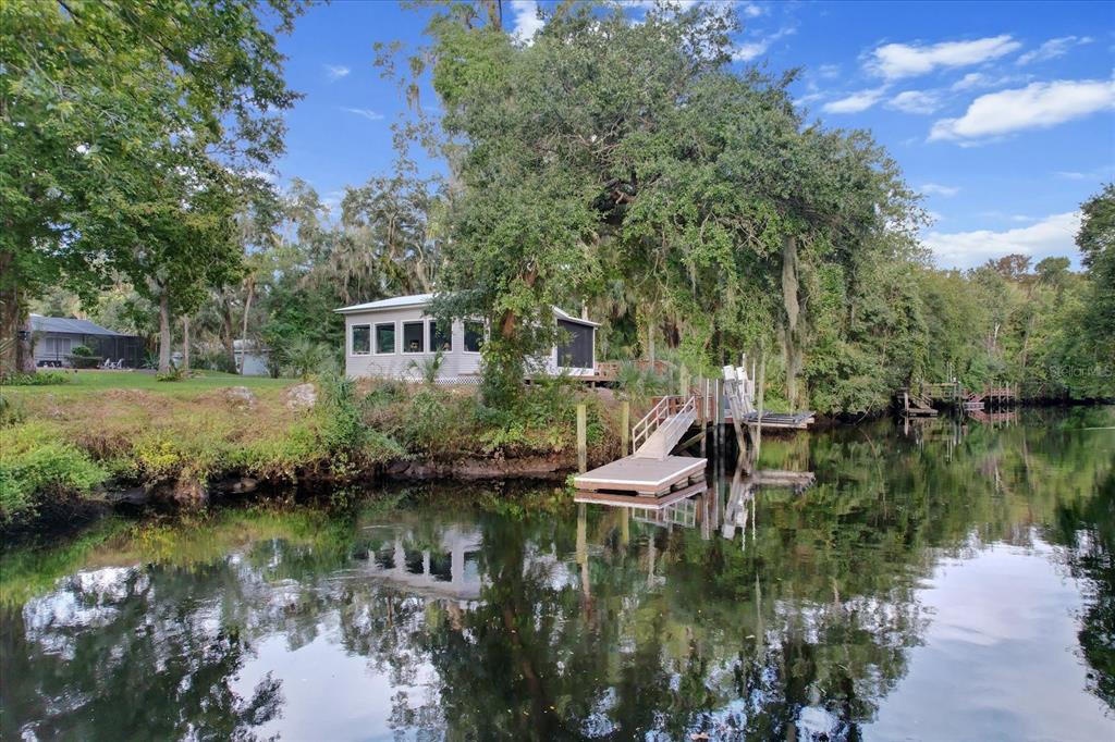 20 Captains Cove Road Inglis, FL 34449 - Photo 82 of 94 a view of a lake with a house in the background