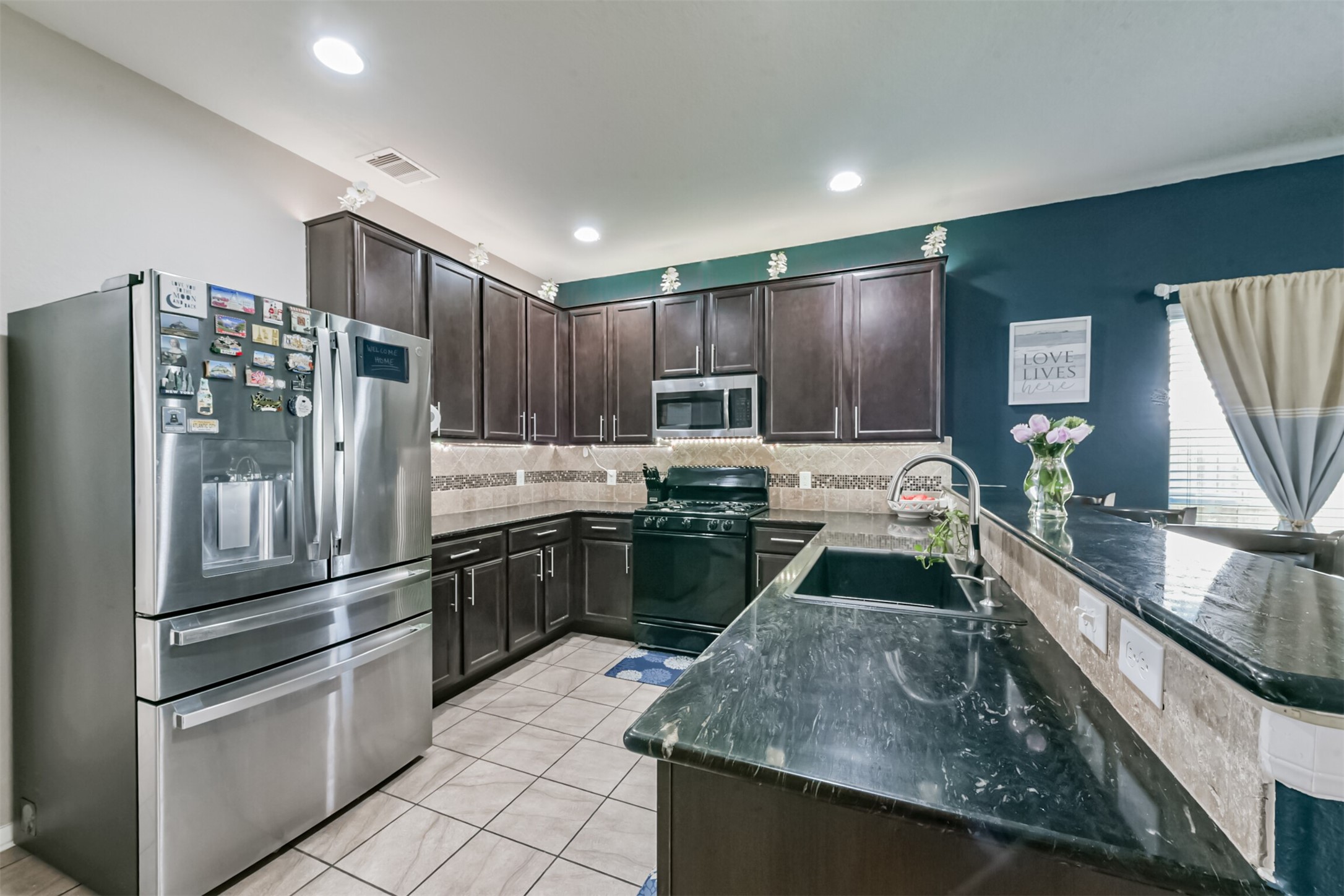 14723 Nickel Plank Road Houston, TX 77049 - Photo 11 of 47 a kitchen with stainless steel appliances granite countertop a sink stove and refrigerator