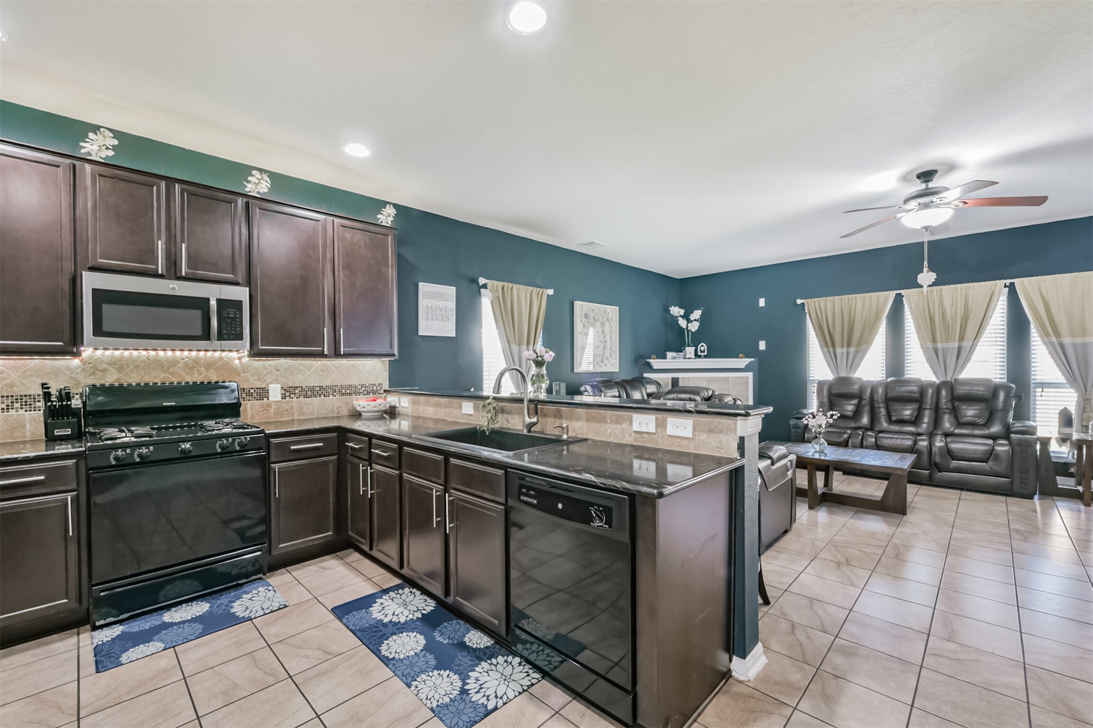 14723 Nickel Plank Road Houston, TX 77049 - Photo 12 of 47 a kitchen with stainless steel appliances granite countertop a stove top oven a sink dishwasher a dining table and chairs