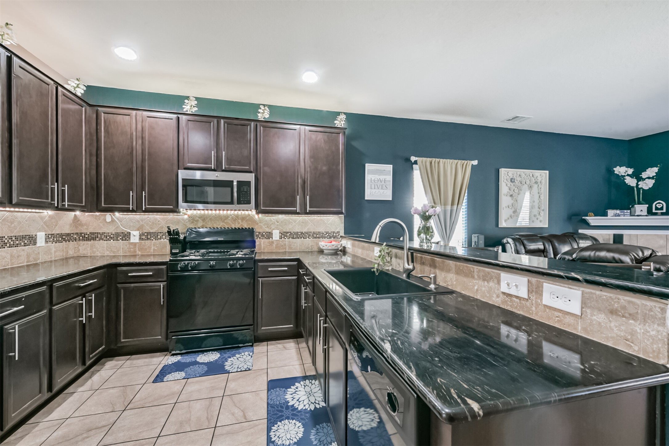 14723 Nickel Plank Road Houston, TX 77049 - Photo 13 of 47 a kitchen with kitchen island granite countertop a sink stainless steel appliances and cabinets