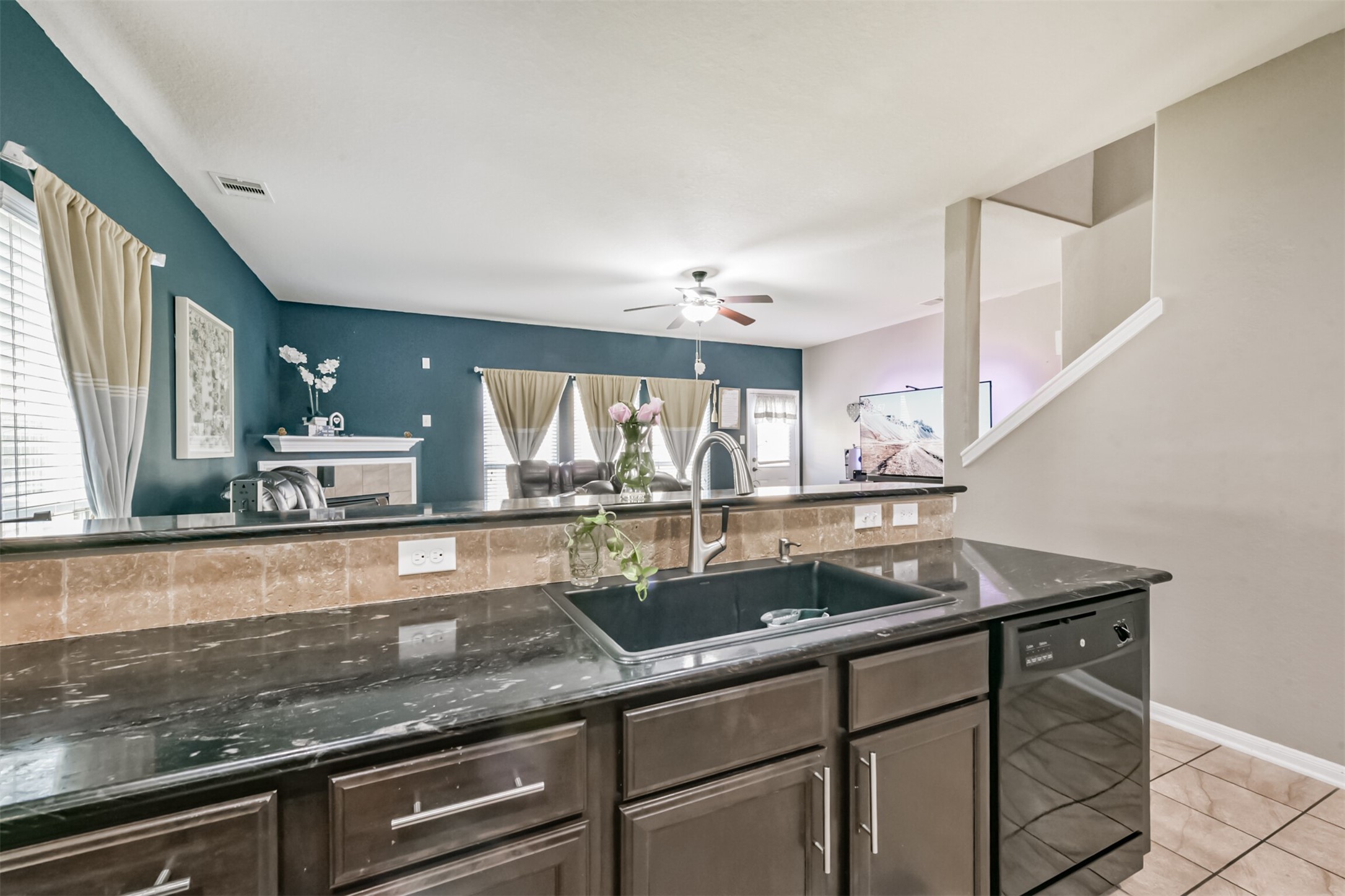14723 Nickel Plank Road Houston, TX 77049 - Photo 14 of 47 a kitchen with a sink and wooden cabinets