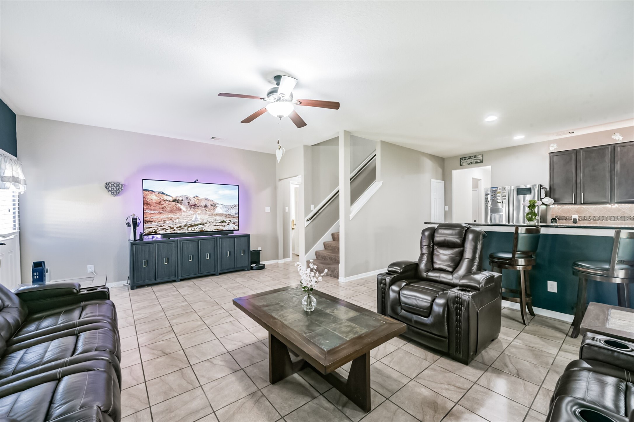 14723 Nickel Plank Road Houston, TX 77049 - Photo 19 of 47 a living room with furniture a flat screen tv and kitchen view