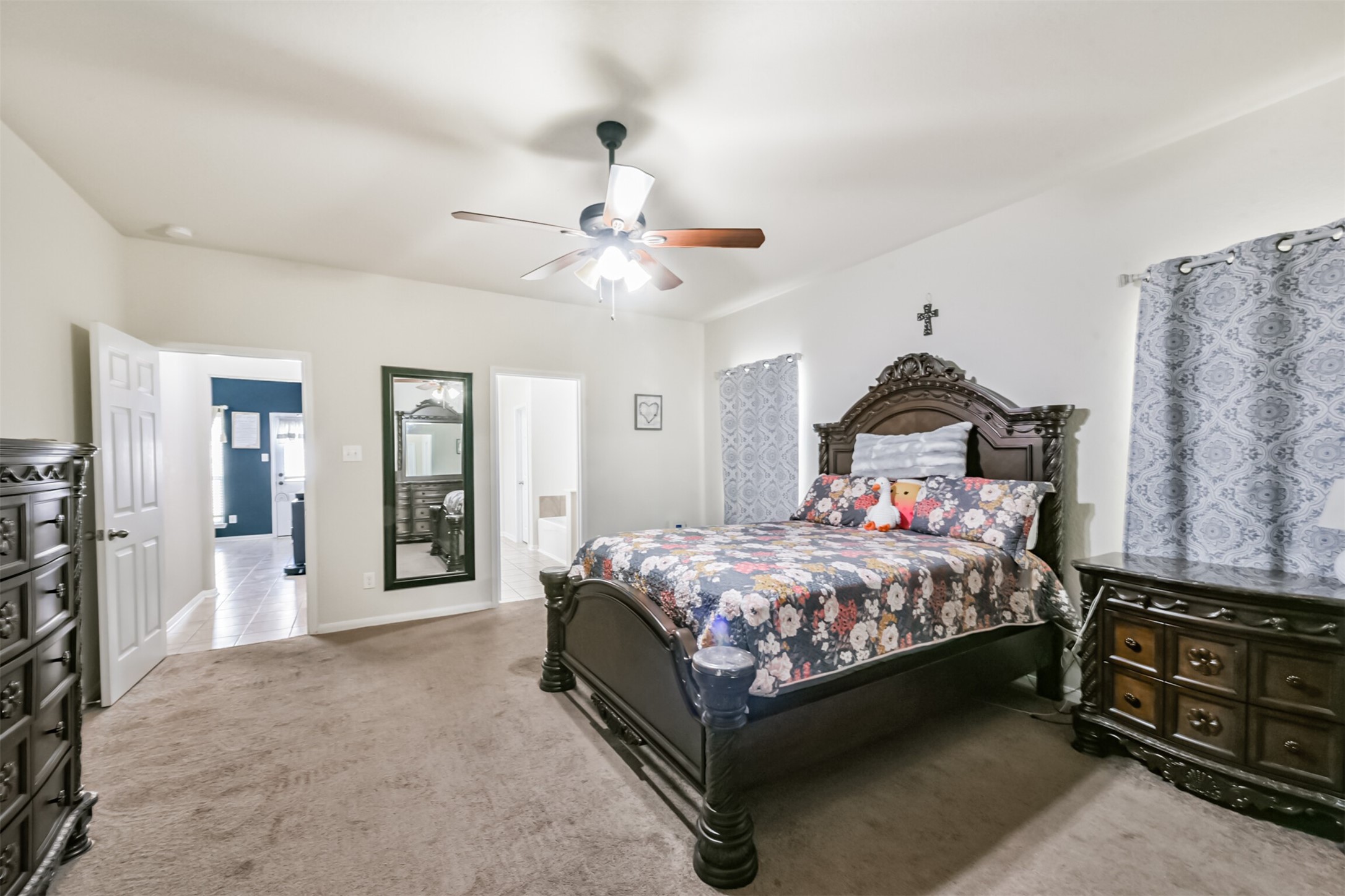 14723 Nickel Plank Road Houston, TX 77049 - Photo 21 of 47 a bedroom with a bed and a chandelier