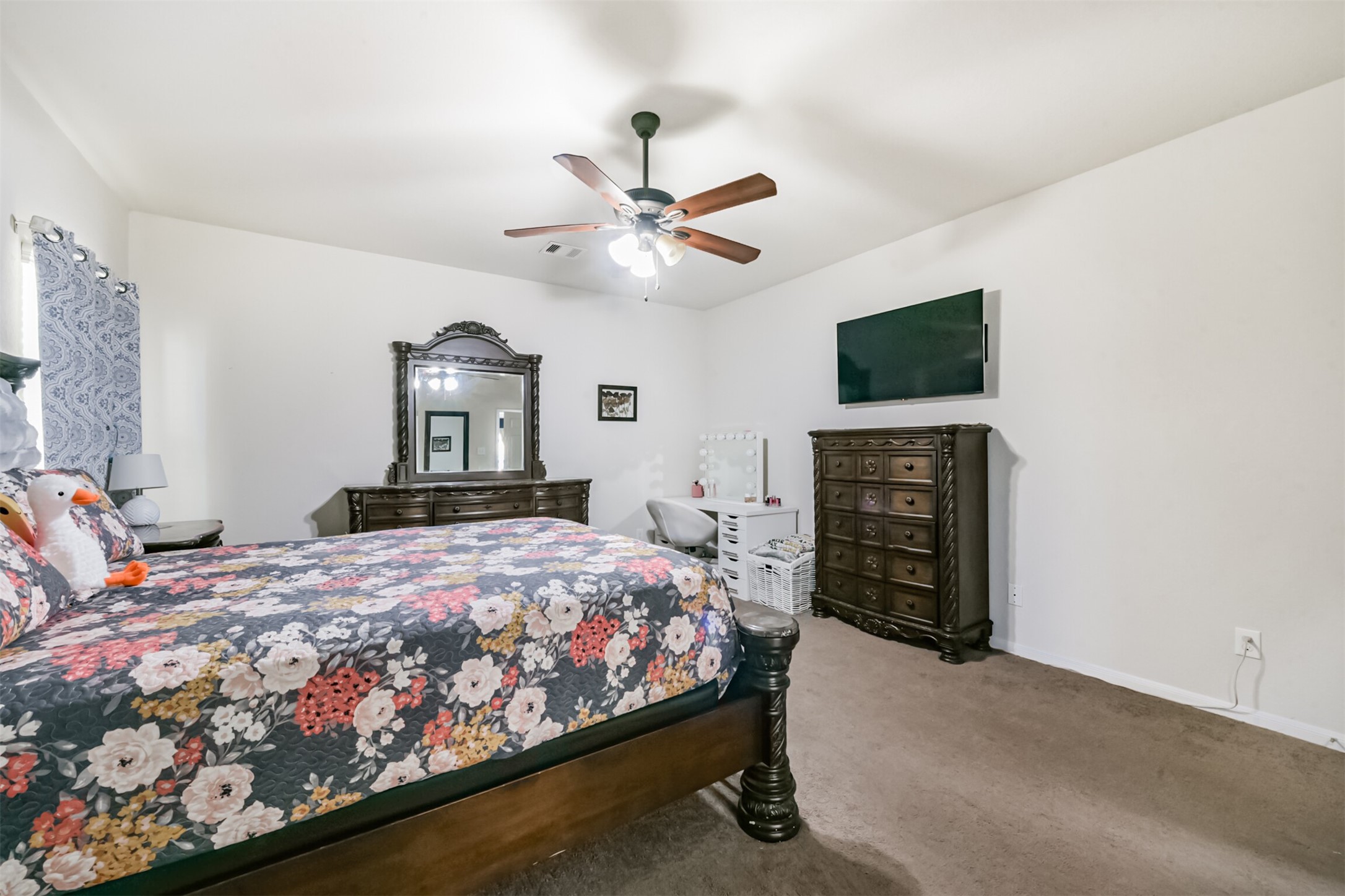 14723 Nickel Plank Road Houston, TX 77049 - Photo 22 of 47 a bedroom with a bed dresser and a flat screen tv