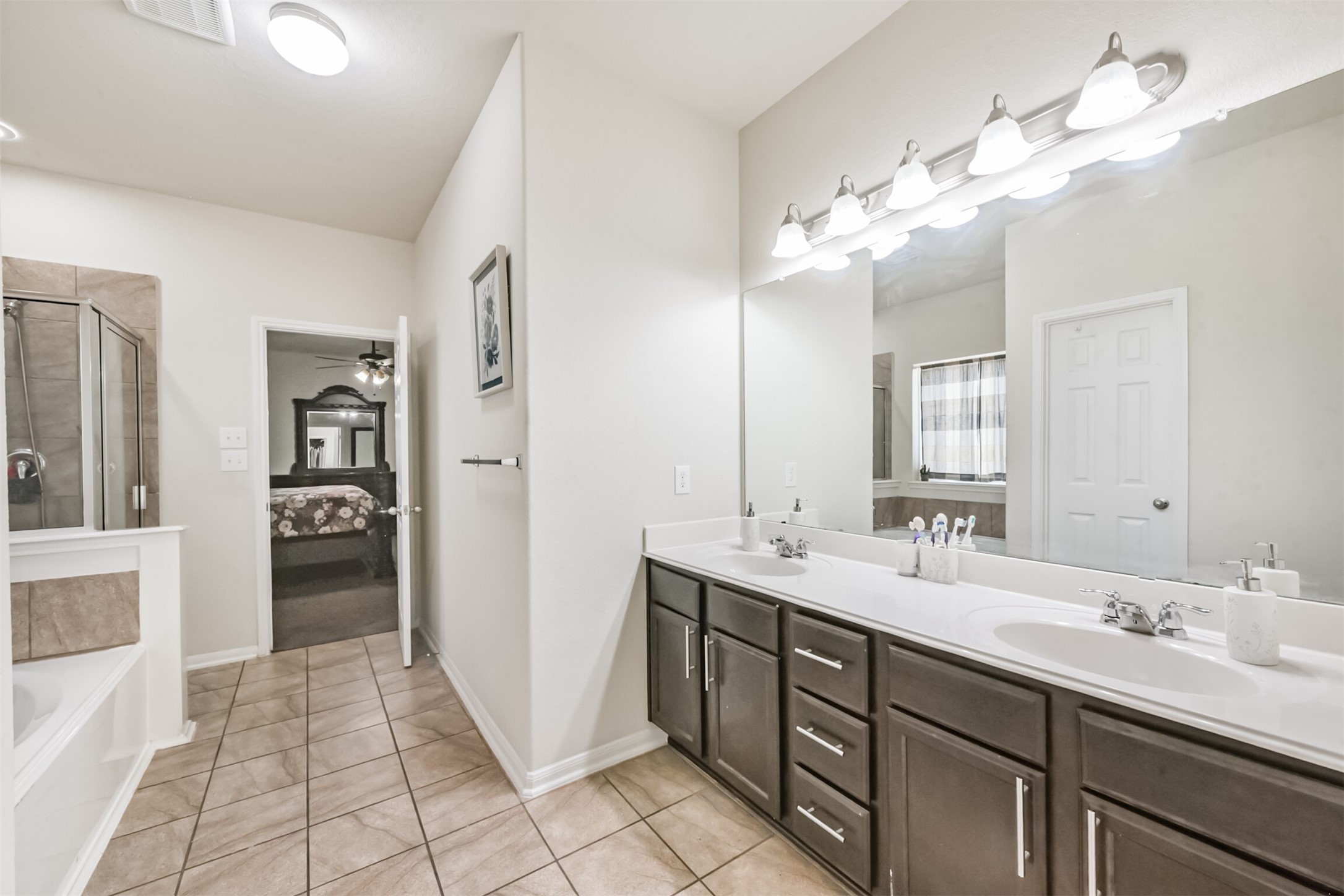 14723 Nickel Plank Road Houston, TX 77049 - Photo 24 of 47 a spacious bathroom with a double vanity sink shower and a mirror