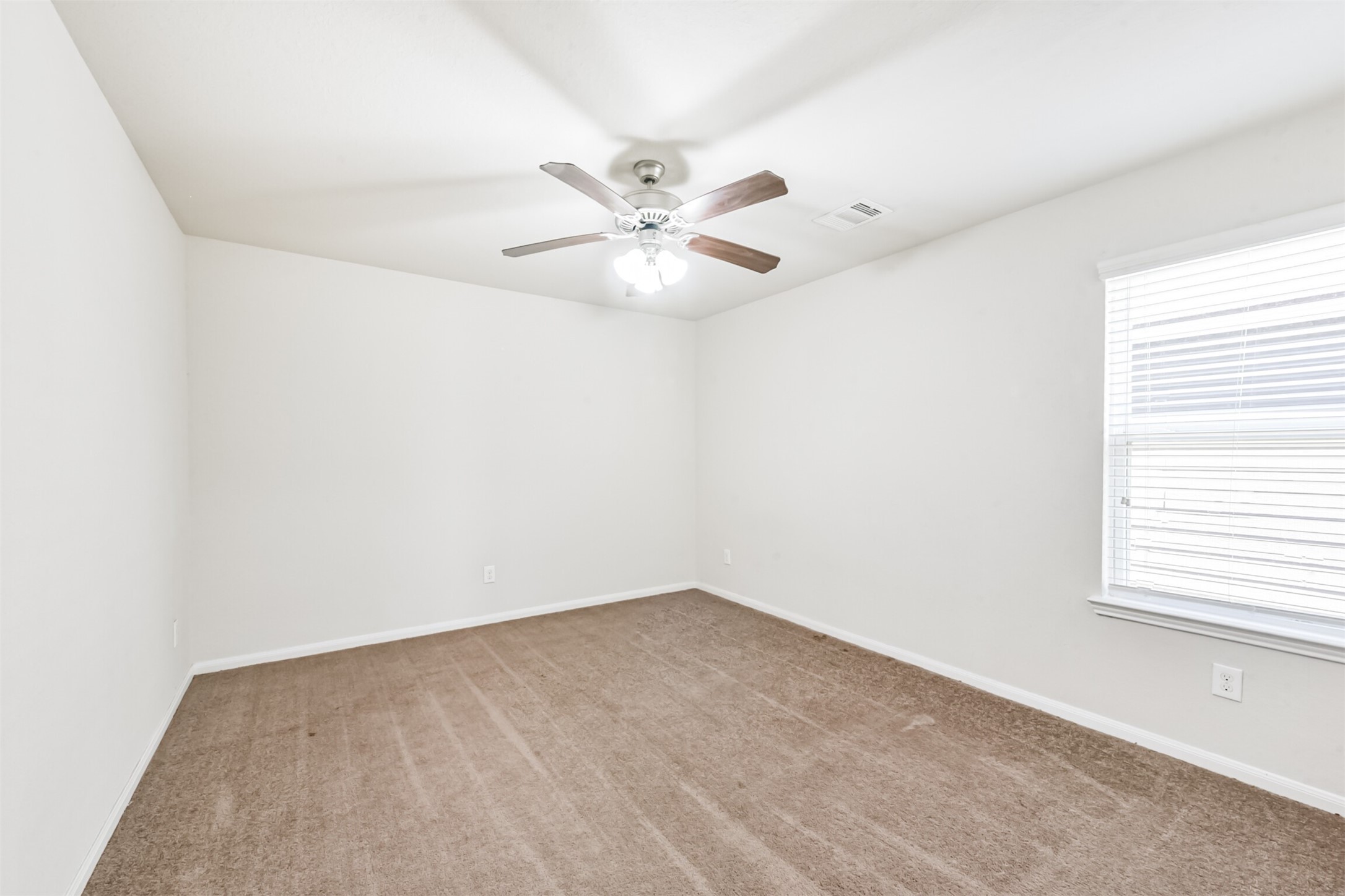 14723 Nickel Plank Road Houston, TX 77049 - Photo 35 of 47 an empty room with windows and fan