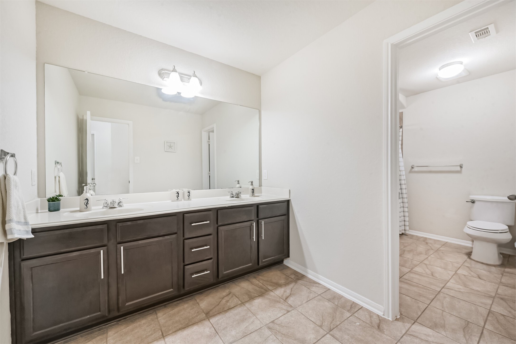 14723 Nickel Plank Road Houston, TX 77049 - Photo 39 of 47 a spacious bathroom with a double vanity sink mirror and toilet