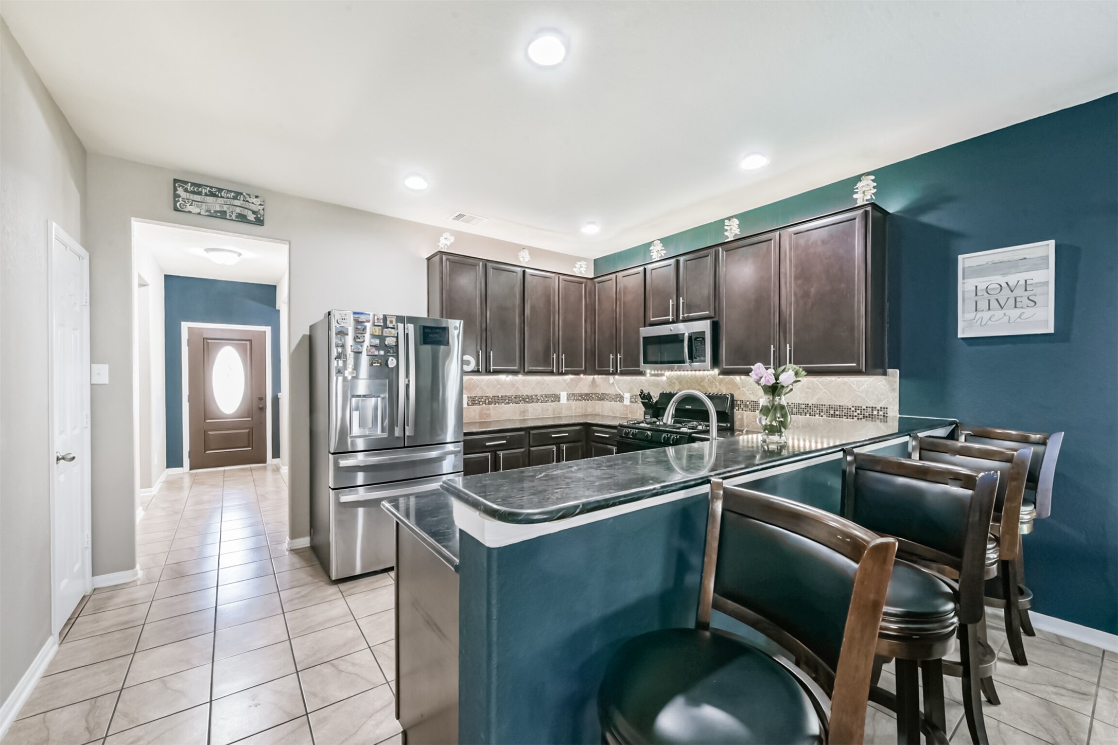 14723 Nickel Plank Road Houston, TX 77049 - Photo 9 of 47 a kitchen with stainless steel appliances granite countertop a sink and cabinets