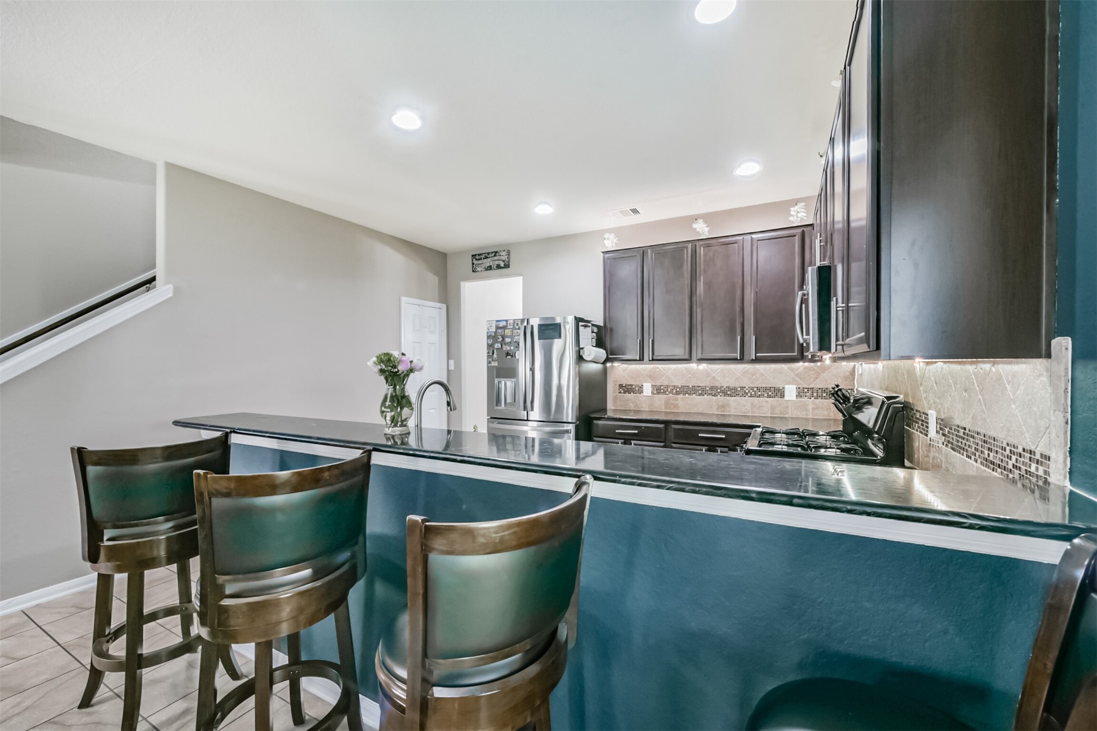 14723 Nickel Plank Road Houston, TX 77049 - Photo 10 of 47 a kitchen with stainless steel appliances a sink a table and chairs