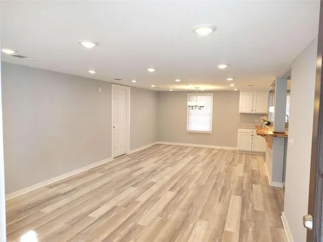 a view of a room with wooden floor and window