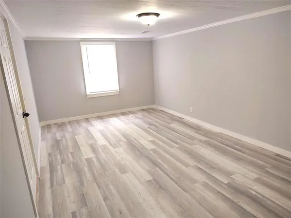 wooden floor in an empty room with a fireplace
