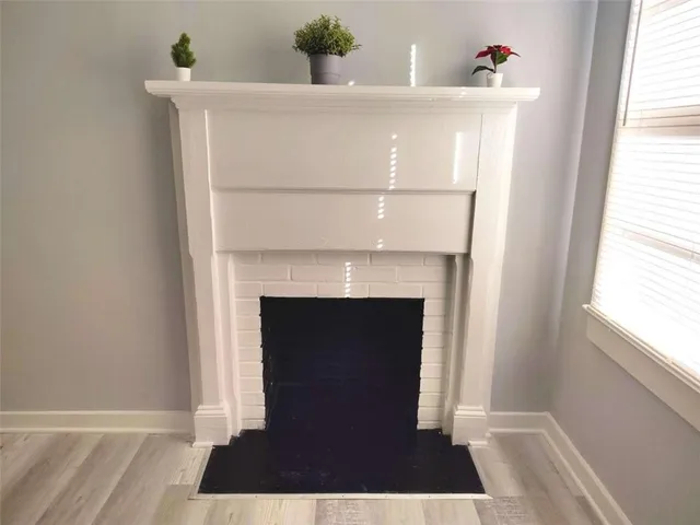 a view of a hallway with wooden floor and entryway