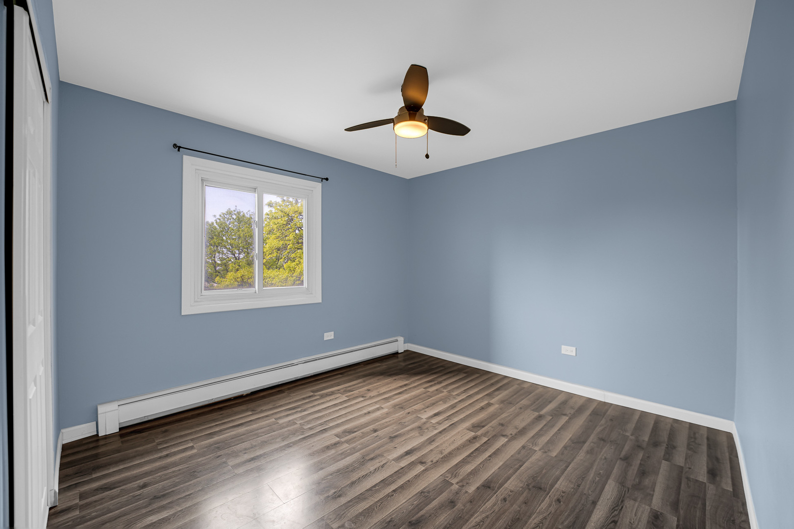 1133 South Finley Road, Unit 310 Lombard, IL 60148 - Photo 13 of 29 an empty room with wooden floor ceiling fan and windows